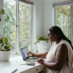 une femme assise à son bureau chez elle